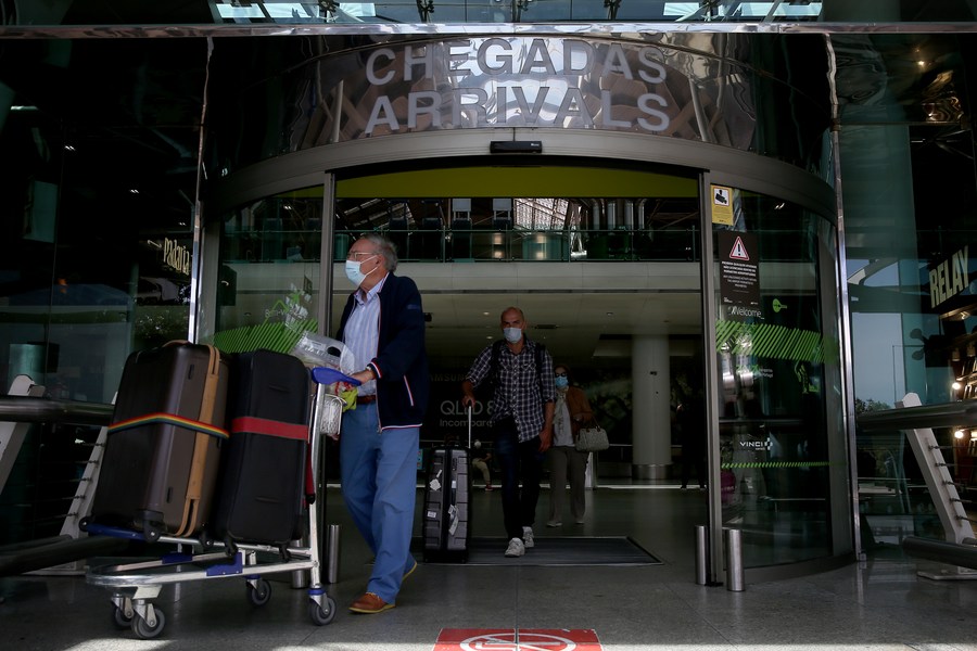 Passengers arrive at Lisbon airport in Portugal on May 19, 2021. (Photo by Pedro Fiuza/Xinhua)