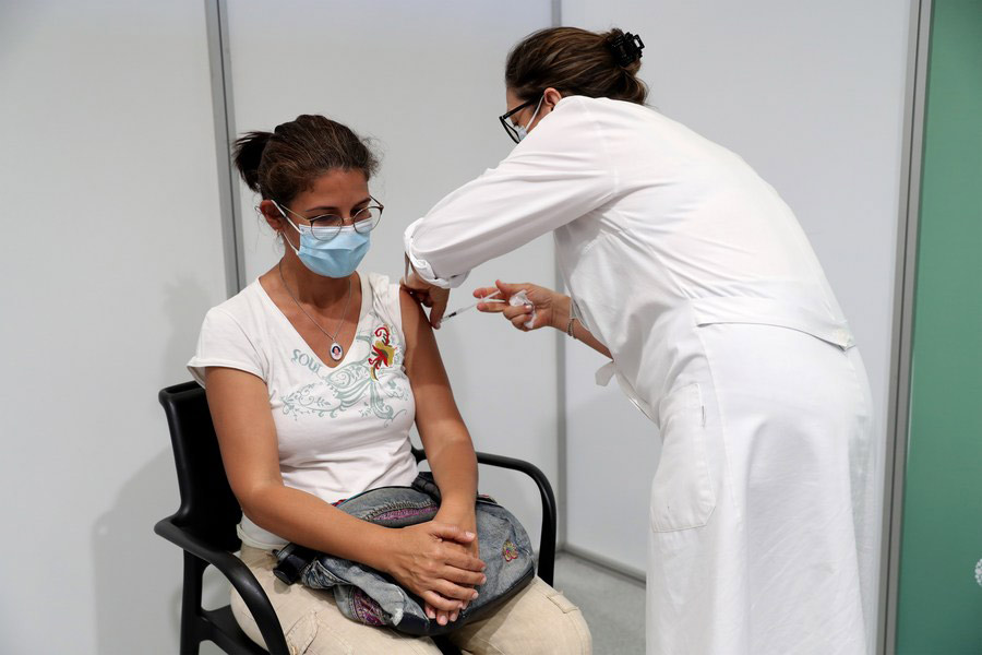 A woman receives a dose of COVID-19 vaccine at a vaccination center at Alcabideche sports complex in Cascais, Portugal, on July 16, 2021. (Photo by Pedro Fiuza/Xinhua)